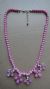 necklace with pink beads and chandelier casting
